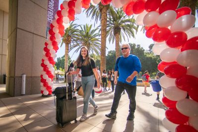 Rhiannon Parker of Laguna Hills, California, walks to Arrillaga Alumni Center with her dad, Clifton.