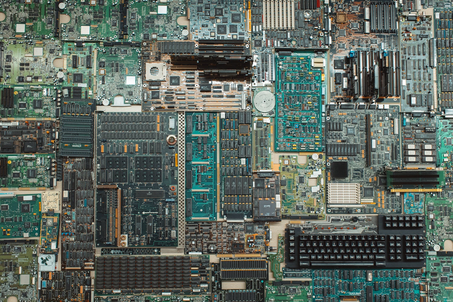 Close-up of the wall hanging, showing various computer parts, including a black keyboard and many green circuit boards