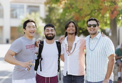 Four students standing arm-in-arm.