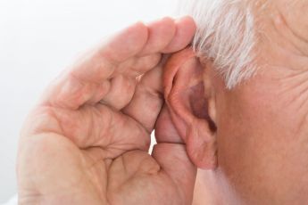 A hand cupping an ear
