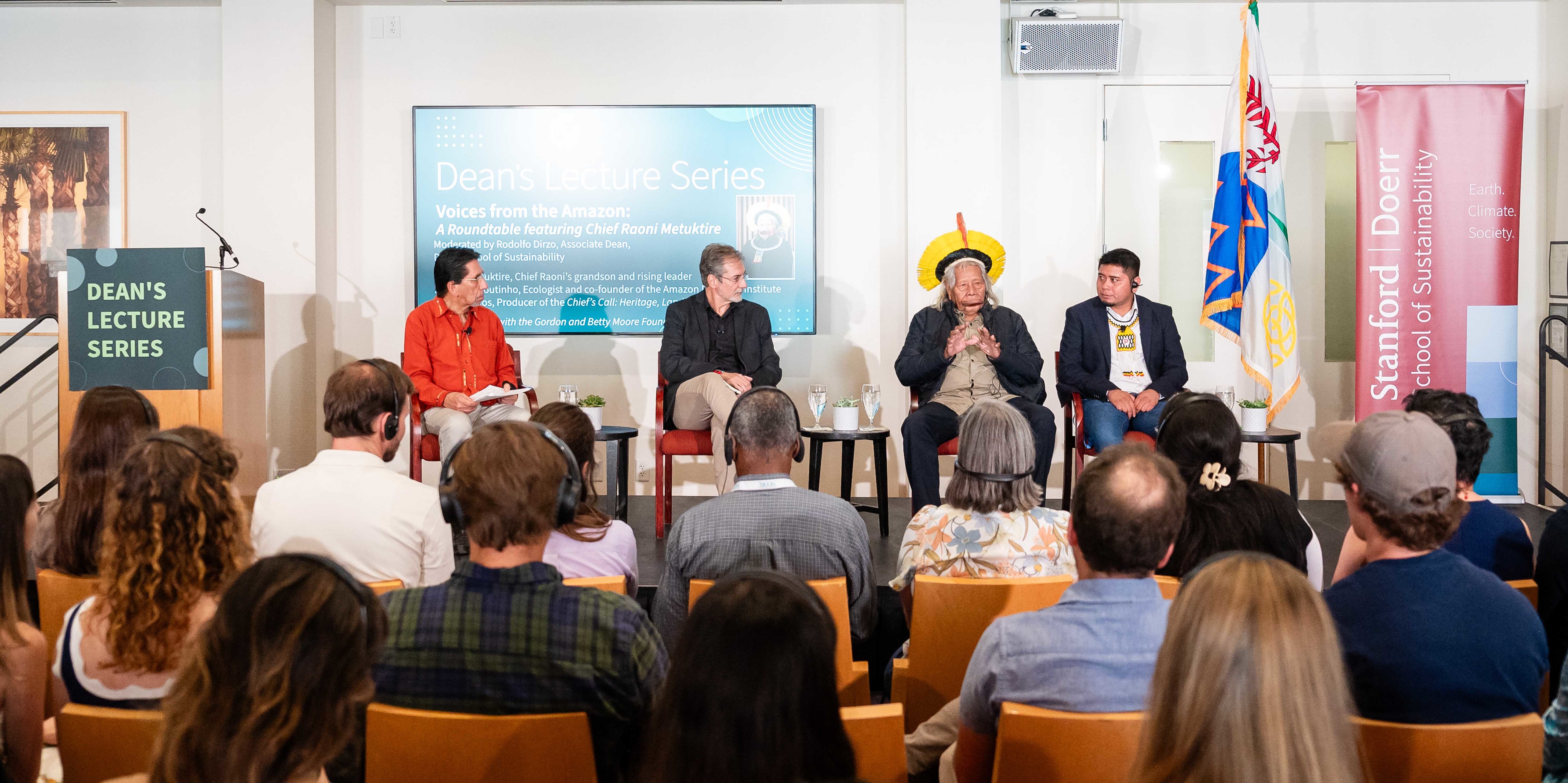 Moderator Rodolfo Dirzo with panelists Paulo Moutinho, Chief Raoni Metuktire, and Beptuk Metuktire on stage