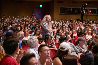 A prospective freshman poses a question at the University Welcome.