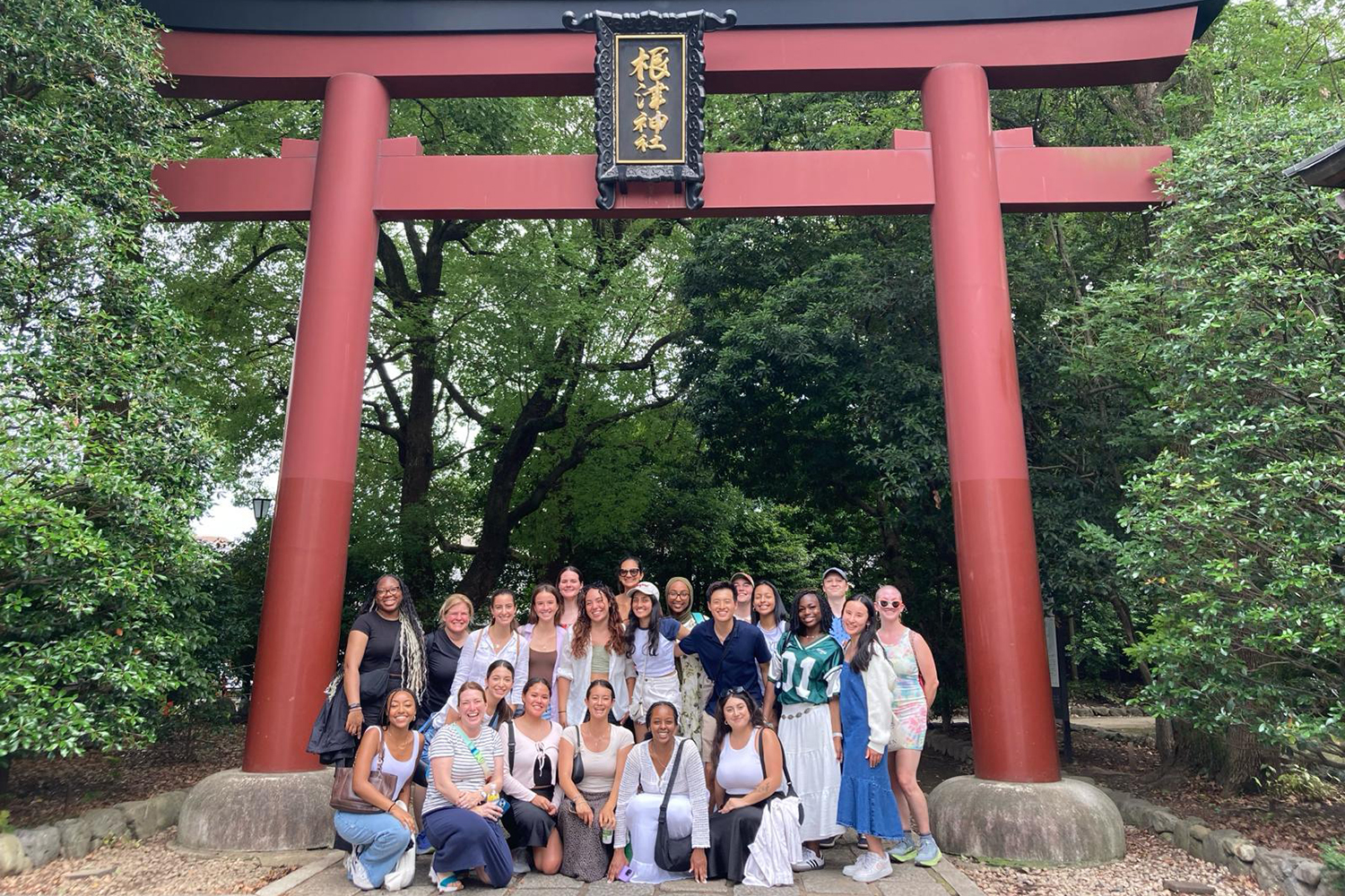 Image of students studying abroad in Japan posing for a photo together under a traditional Japanese gateway.