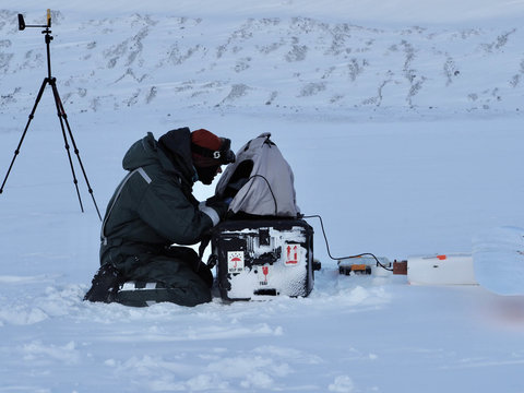 In Svalbard, Thomas Teisberg reviews a flight plan for the Peregrine UAV before launch on an ice field