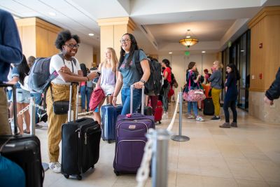 Gabby Crooks of Germantown, Maryland, and Selaine Rodriguez of El Paso, Texas, get to know each another while checking their luggage.