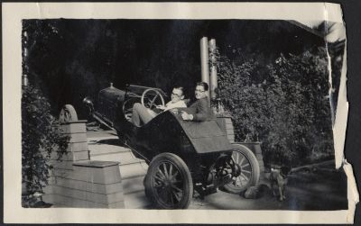 students driving a car up the stairs to a house in 1929