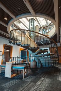 Spiral staircase winding around a tube-shaped display case