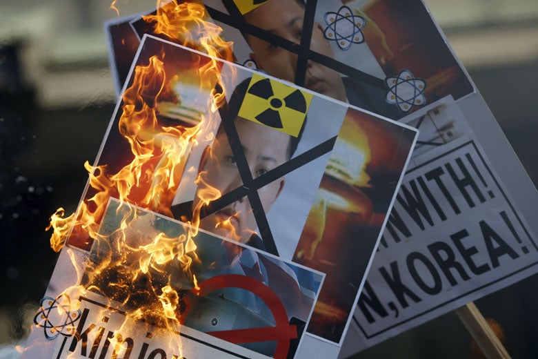 protest signs against Kim Jong-un and nuclear testing