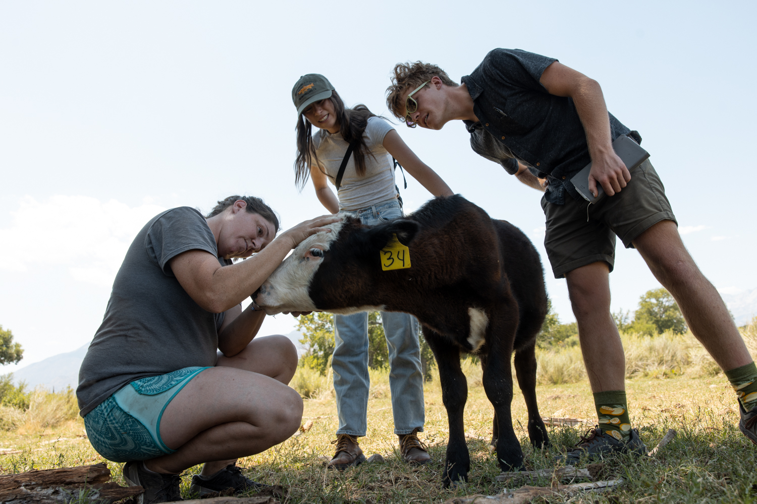 Photo of Emma Sage and Kyler Keller standing with a calf.