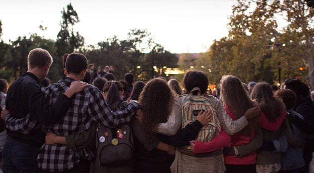 Students linked arm and arm at vigil