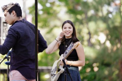 Two students on stage with guitars.