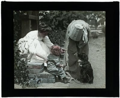 Harry Peterson, the first curator of the Leland Stanford Jr. Museum (now the Cantor Arts Center), was also a photographer. This image from his Home Series features his wife and son enchanted by a charming black dog.
