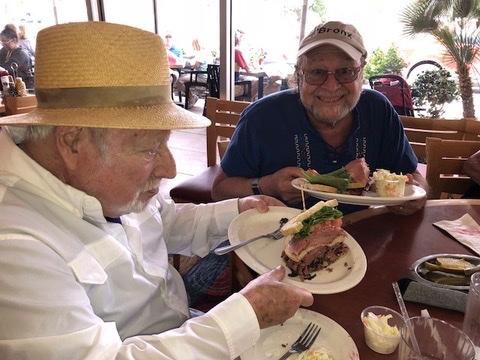 Lee Shulman (left) and David Berliner eat pastrami sandwiches together at a delicatessen, one of many favorite pastimes they shared.