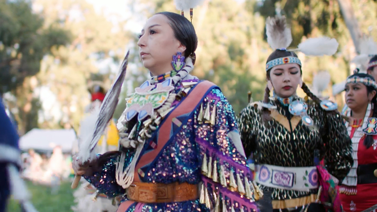 Women in regalia at 2024 Stanford Powwow (opens in a modal)