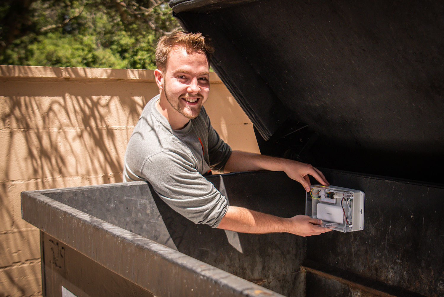 Backus places sensor in dumpster.