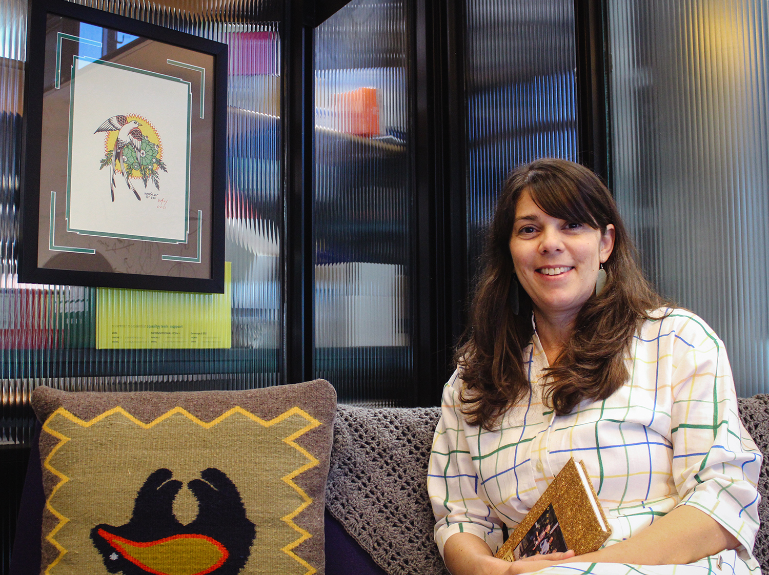 Kristy Red-Horse in her office with Native American art