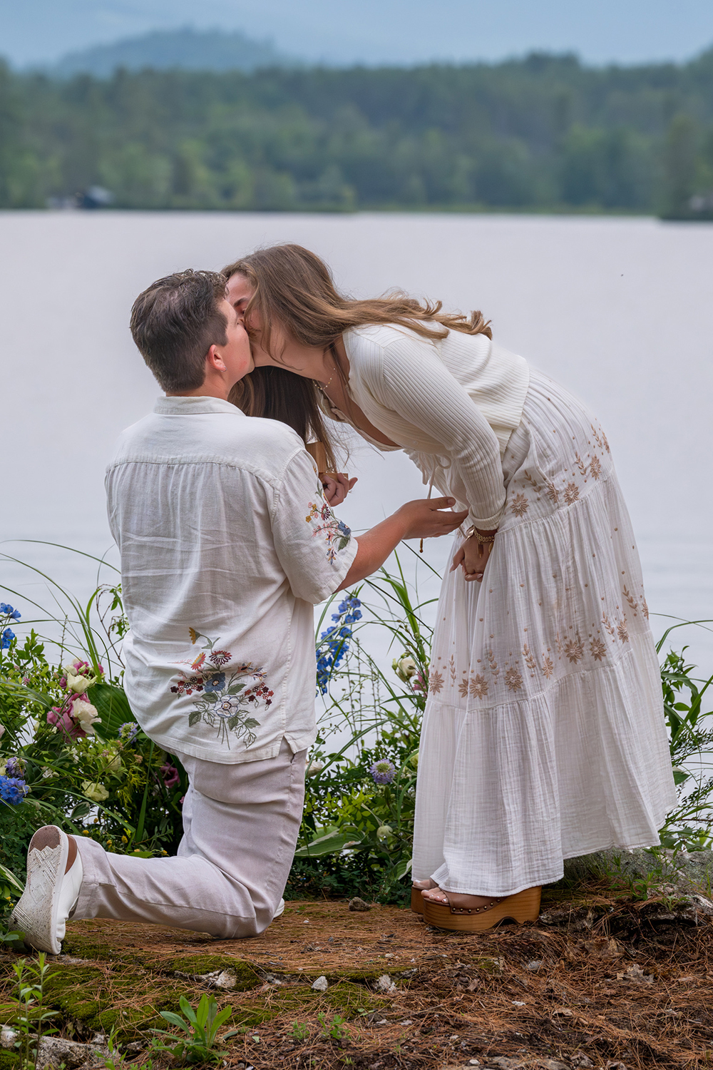 Image of Dahkota Brown proposing on one knee to Caroline Kushel.