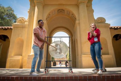 Chinemere Uche of Maumee, Ohio, rings the gong with Stanford student Sofia Dudas to celebrate his intention to attend Stanford.