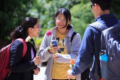 Student holding a flower.