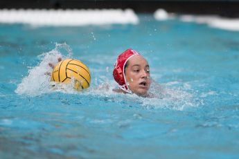 Maggie Steffens with the ball in a water polo match.