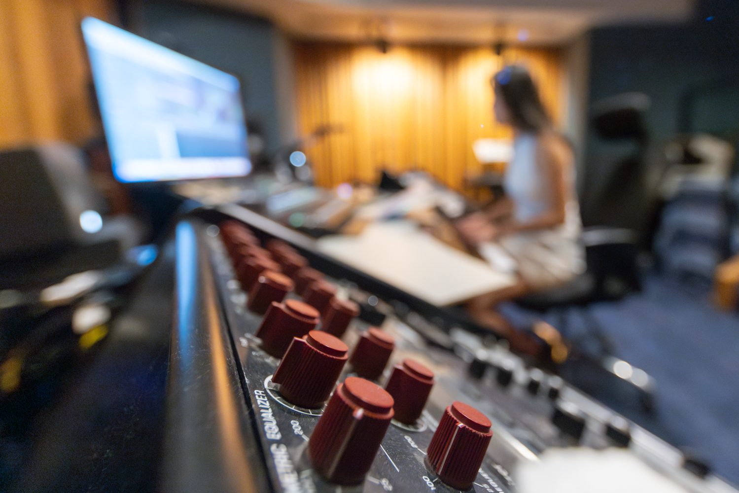 A close up image of a sound board in a music studio.
