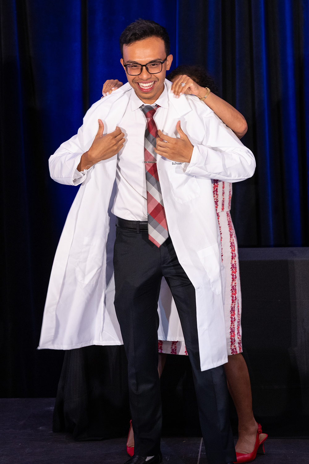  Students receives his coat on stage.