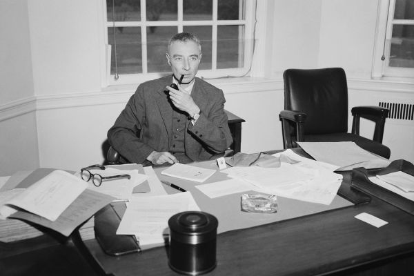 Dr. J. Robert Oppenheimer, suspended Atomic Energy Commission consultant, smokes at his desk at the Princeton Institute for Advanced Study. June 2, 1964.
