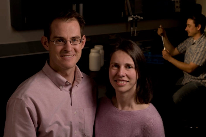 A man and woman stand together in a lab.