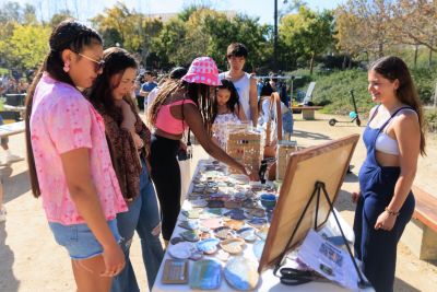 Students shopping for jewelry at a vendor's table