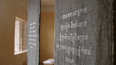 hanging banners with embroidered writing in Khmer (Cambodian) script