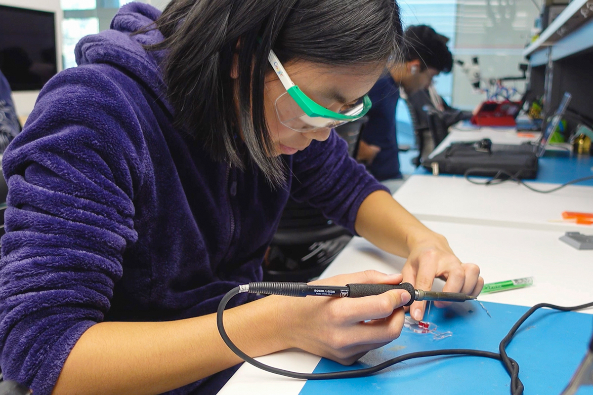 A student soldering LEDs during a workshop (opens in a modal)