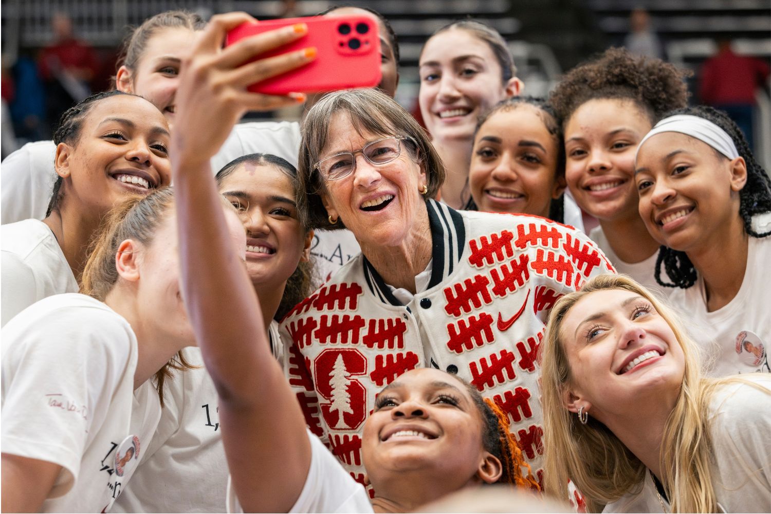 Tara VanDerveer takes a selfie with the women's basketball team.