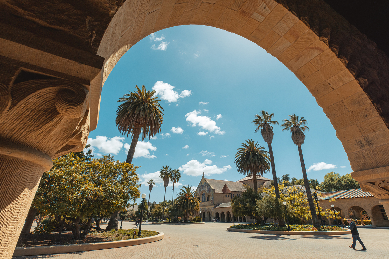 Memorial Church and the surrounding Main Quad are framed by a sandstone arch.