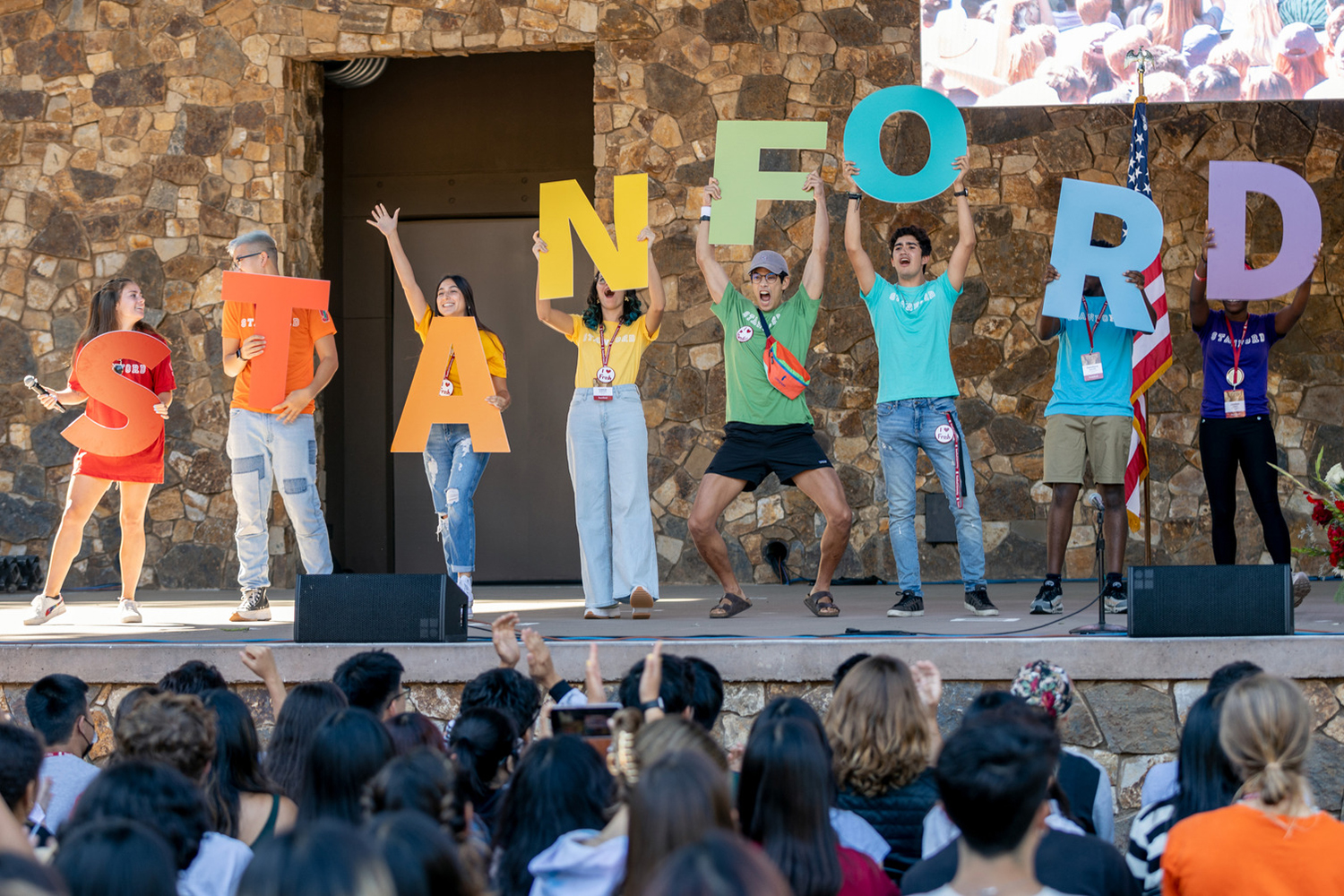 Students hold colorful letters spelling out STANFORD