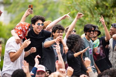 Students waving their arms in the air.