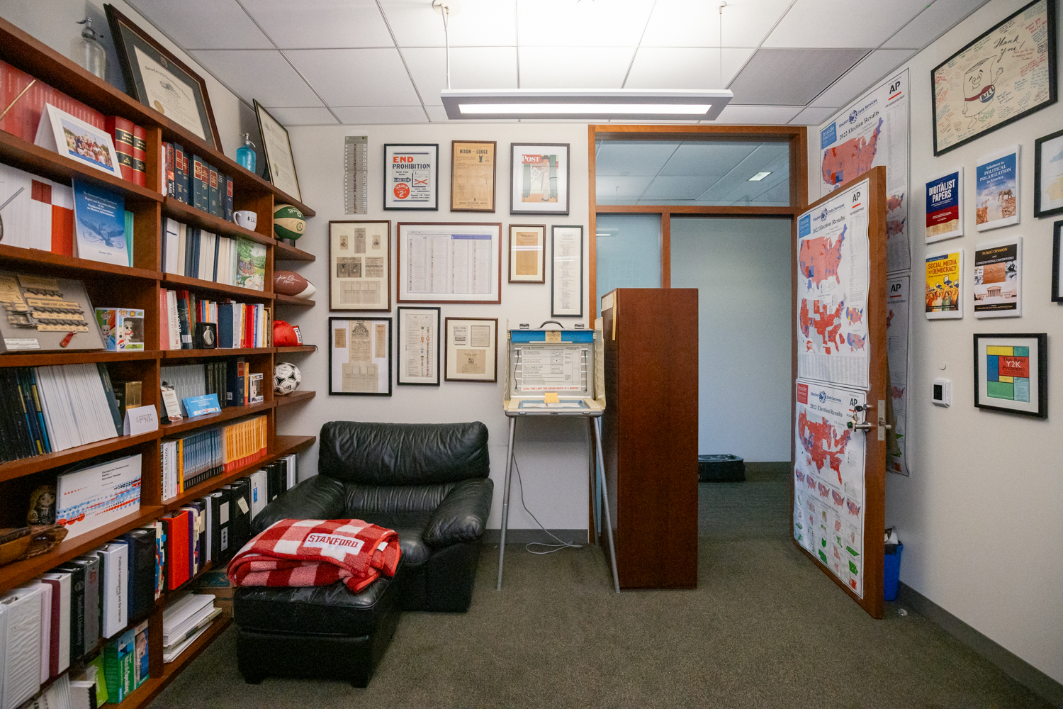 Office walls are covered framed maps of the districts he’s helped to redraw over the years.