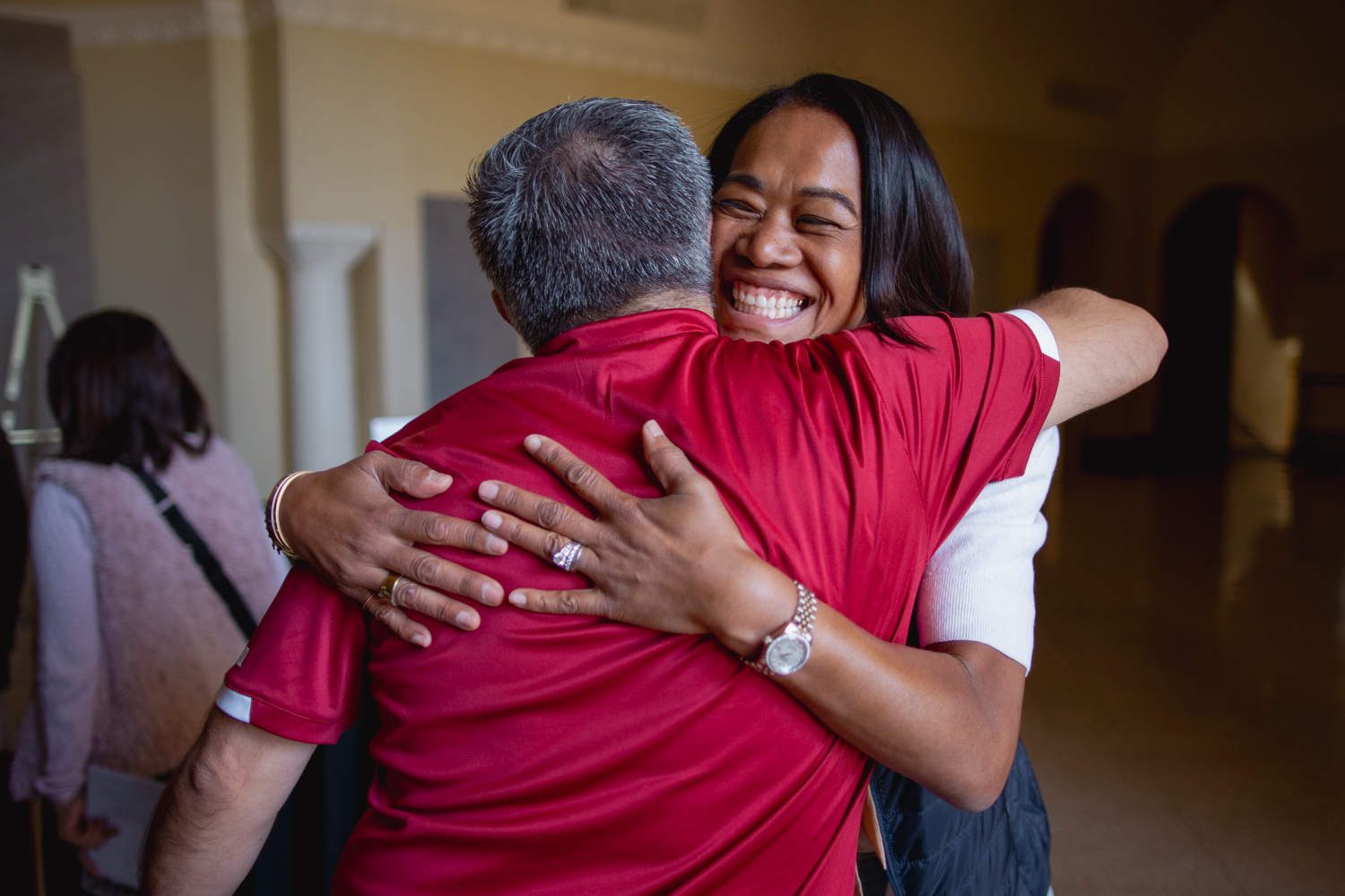 Student and family member hug.