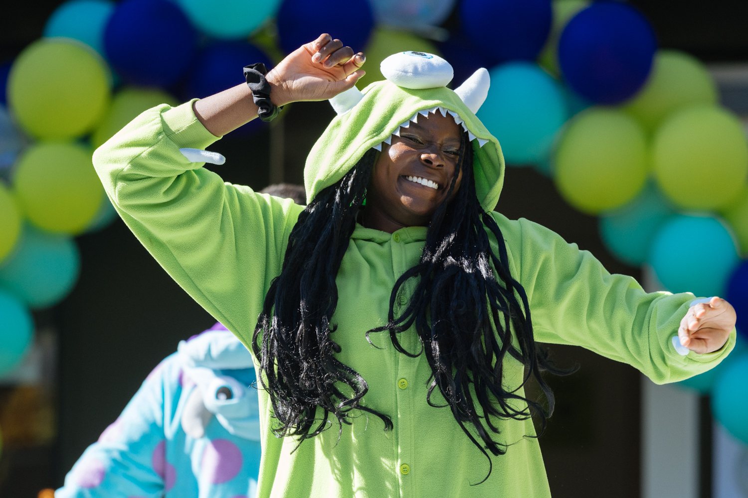 Orientation coordinator in costume dances joyously.