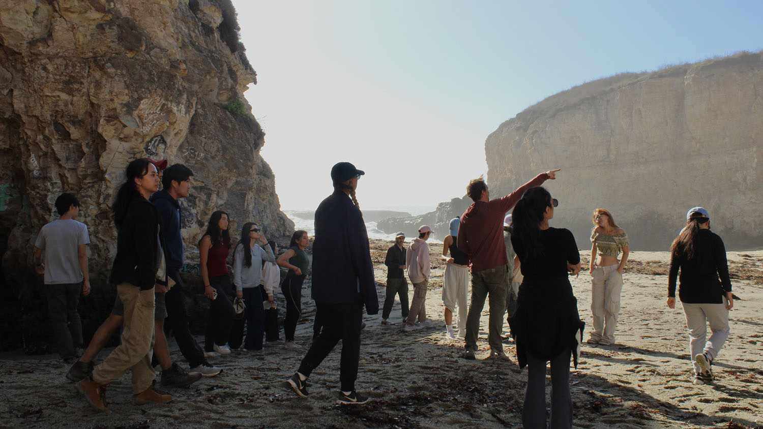 Image of students walking along the beach at Shark Fin Cove as EPS 5 field course instructor Steve Cole Dobbs guides them through a lesson.