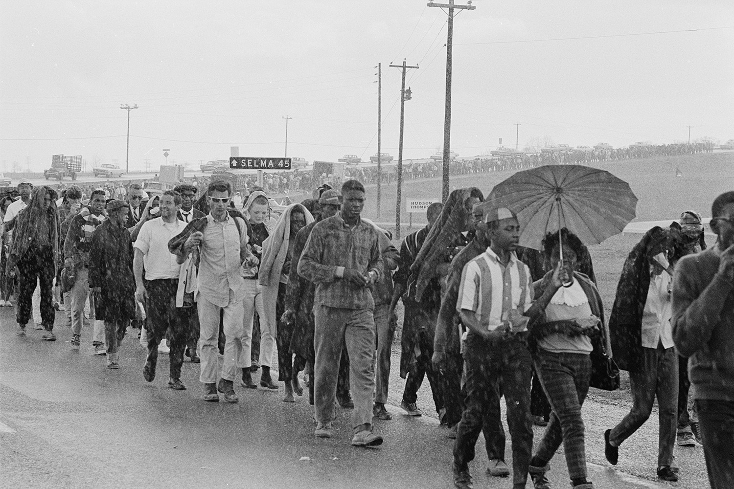 Marchers walk in the rain.