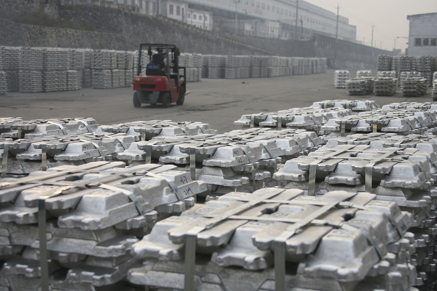 Workers transport aluminum ingots