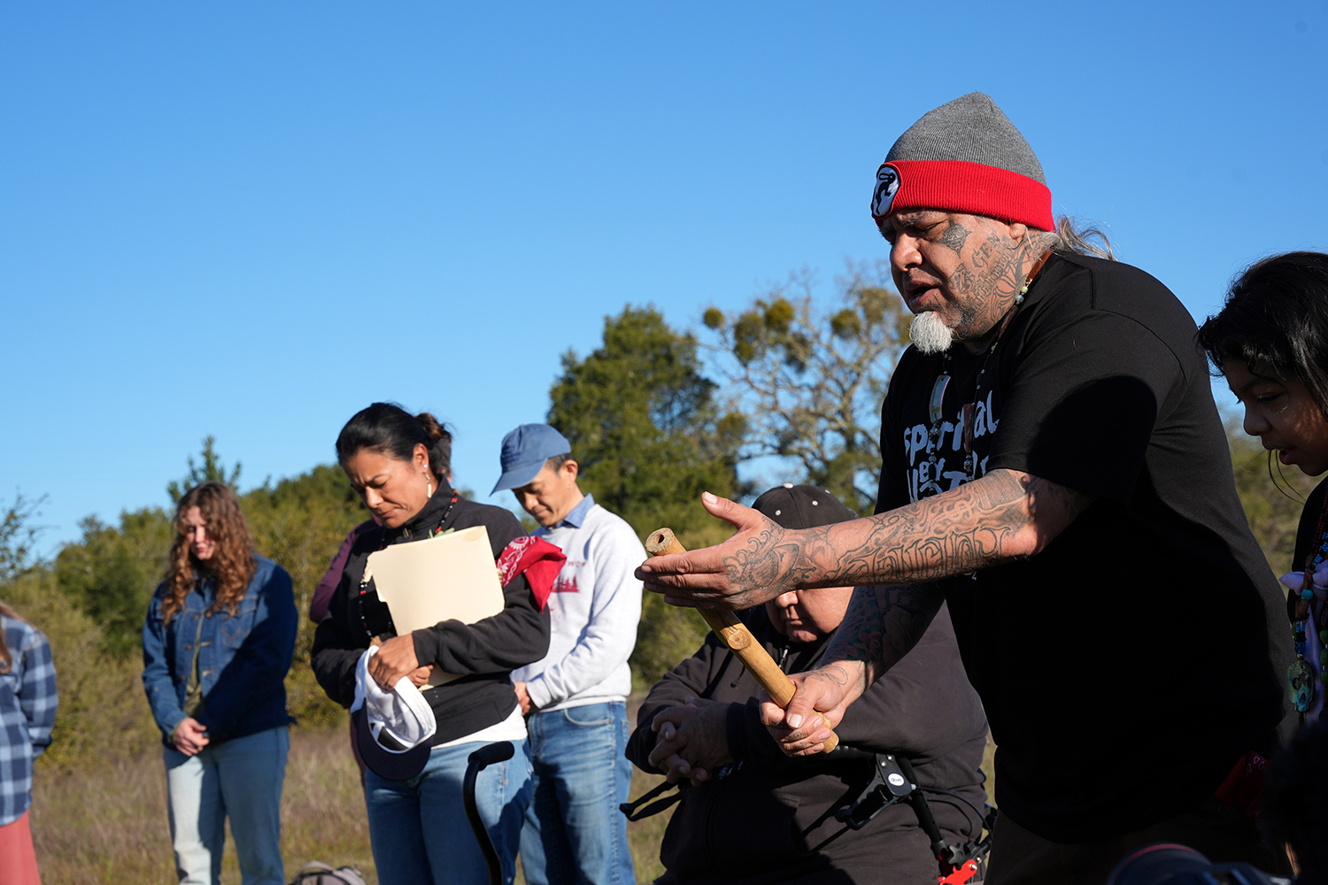 Joey Iyolopixtli Torres leading a group in prayer during a pre-burn ceremony. 