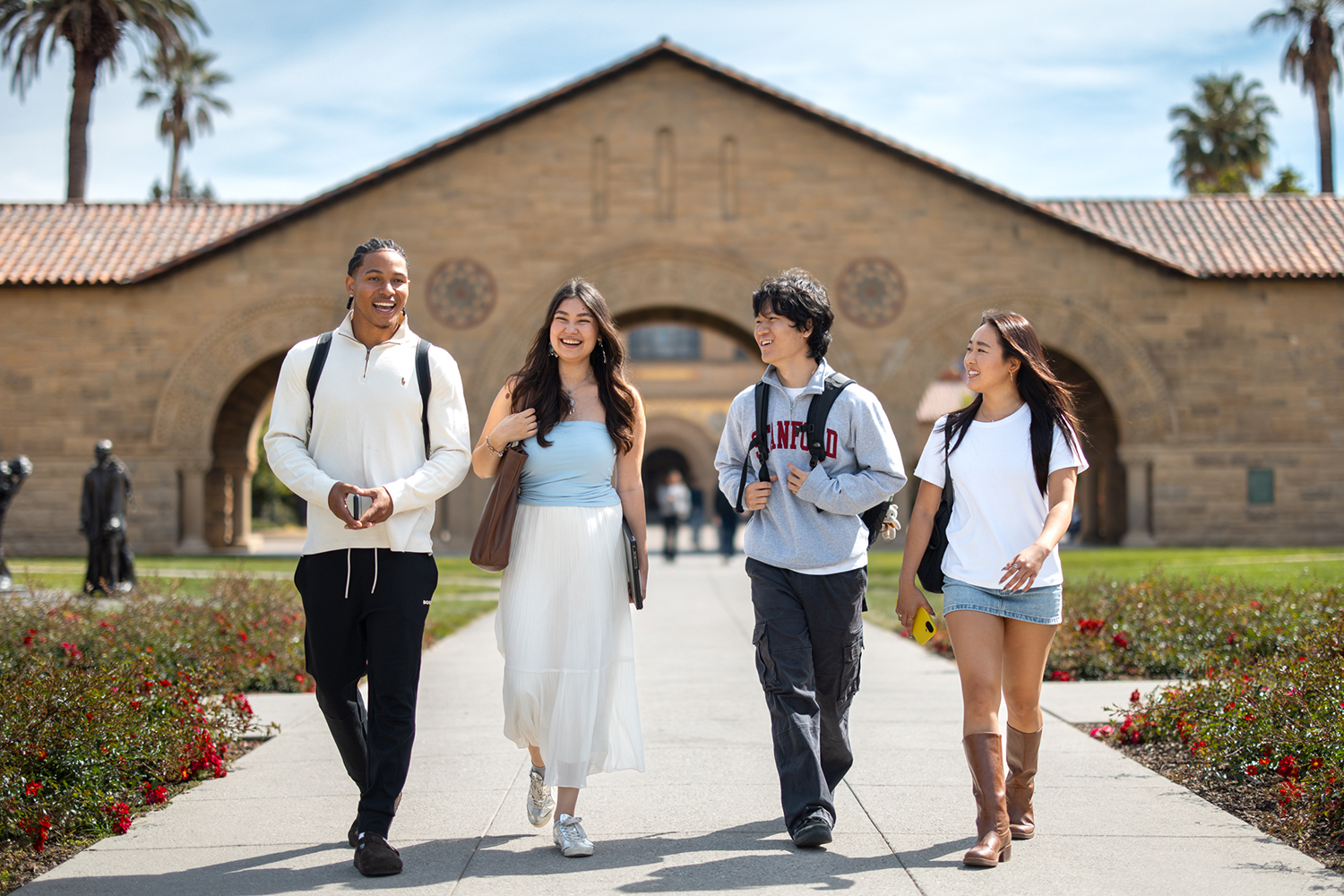 Open video Four students walking together through the Main Quad on the Stanford campus. in a modal