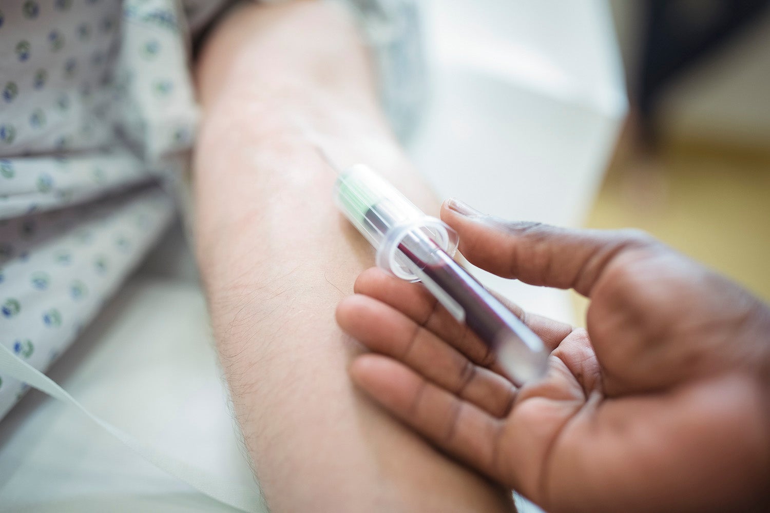 Close-up of doctor collecting blood sample from a patient