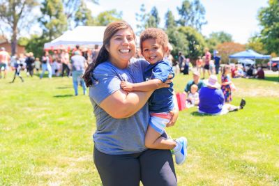 Parent holding a child.