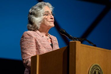 Persis Drell speaks from the lectern in Memorial Auditorium