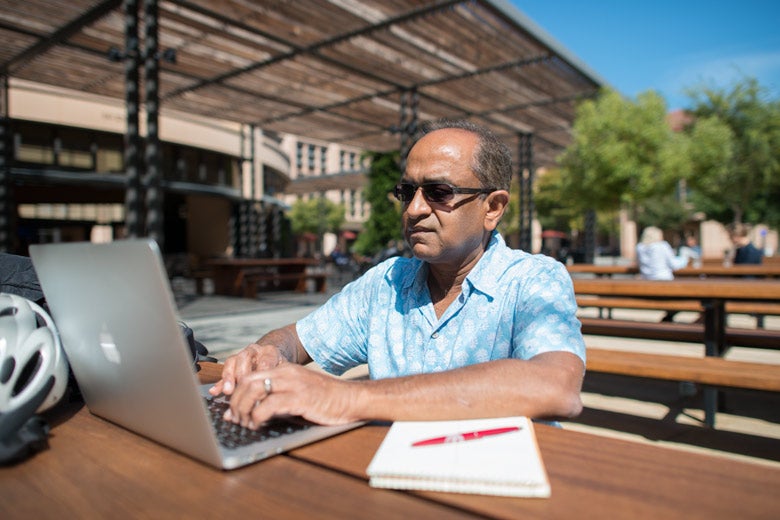 Raj Bhargava working on his laptop