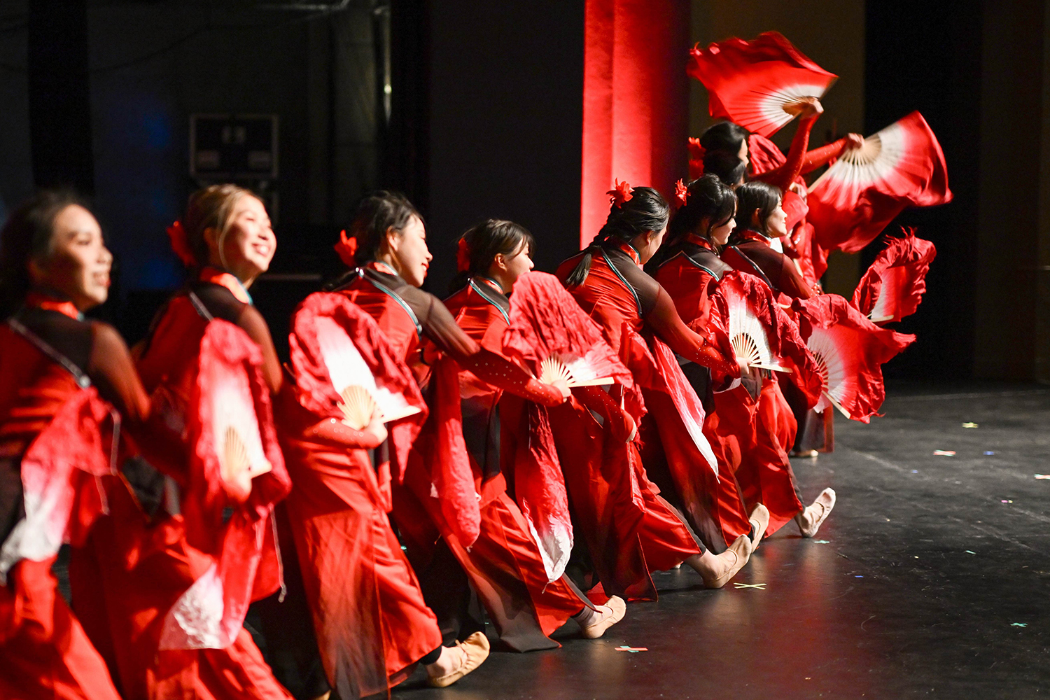 Dancers in red costumes perform