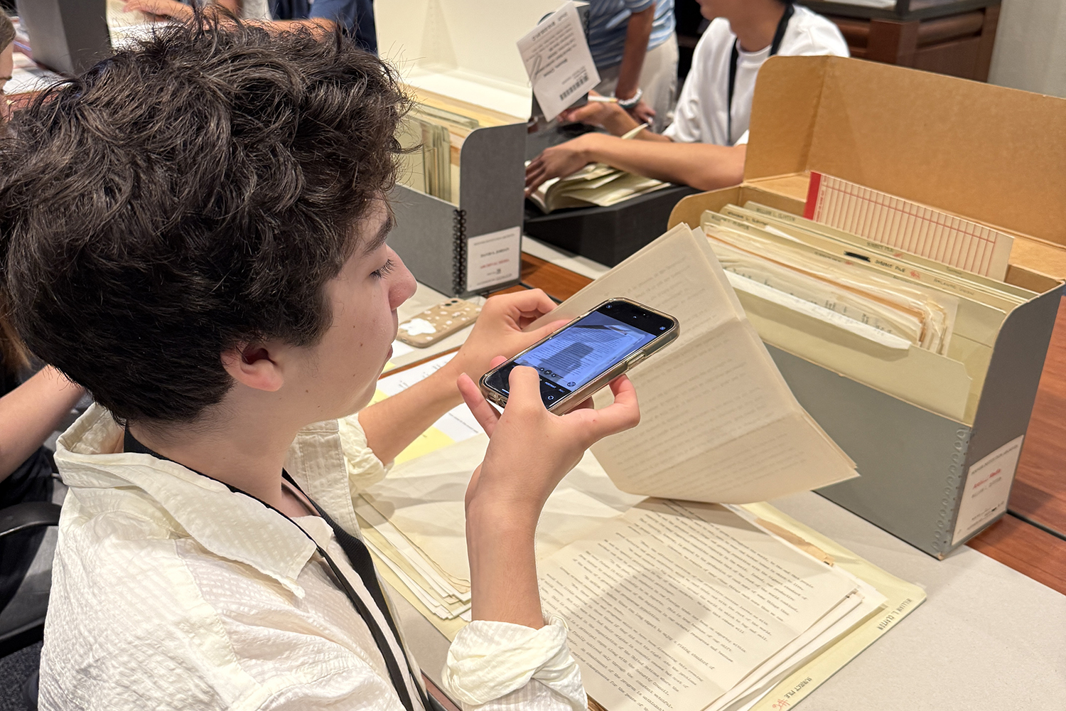 Image of A Hoover History Skills Academy participant photographs a document housed at Hoover’s Library & Archives.