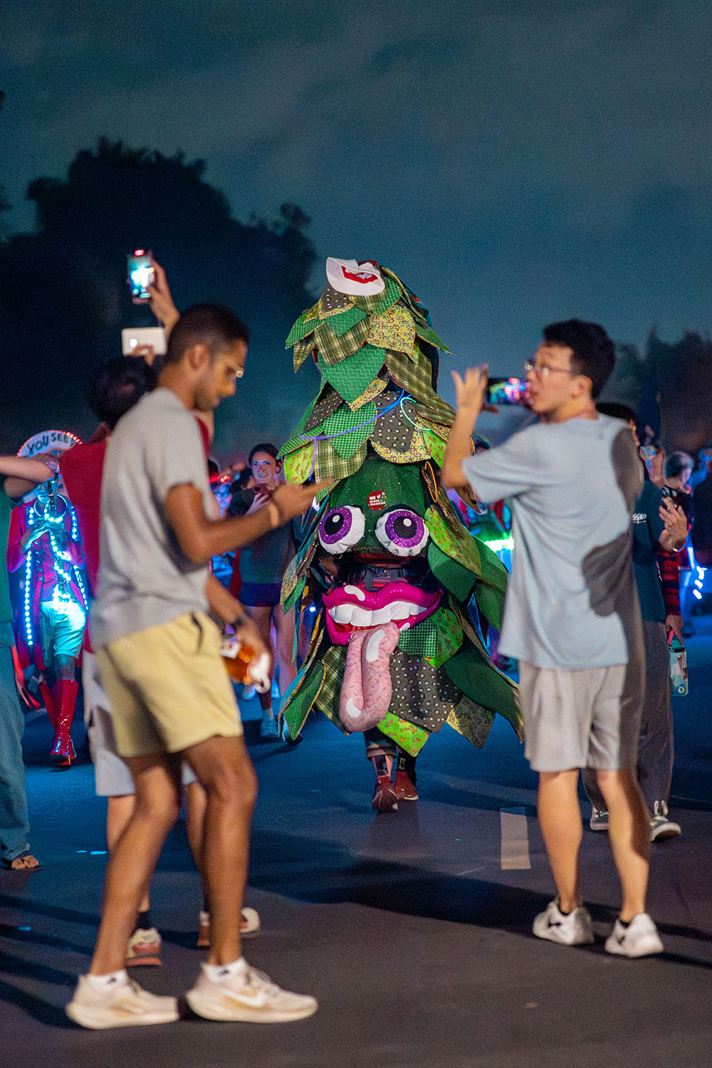 Students take photos of the Tree, the band's mascot.